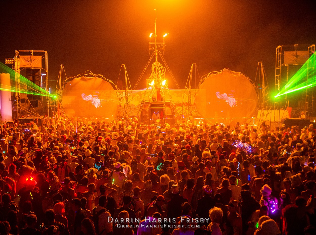 Wide view of the Opulent Temple audience, lasers, flames, and circular screens